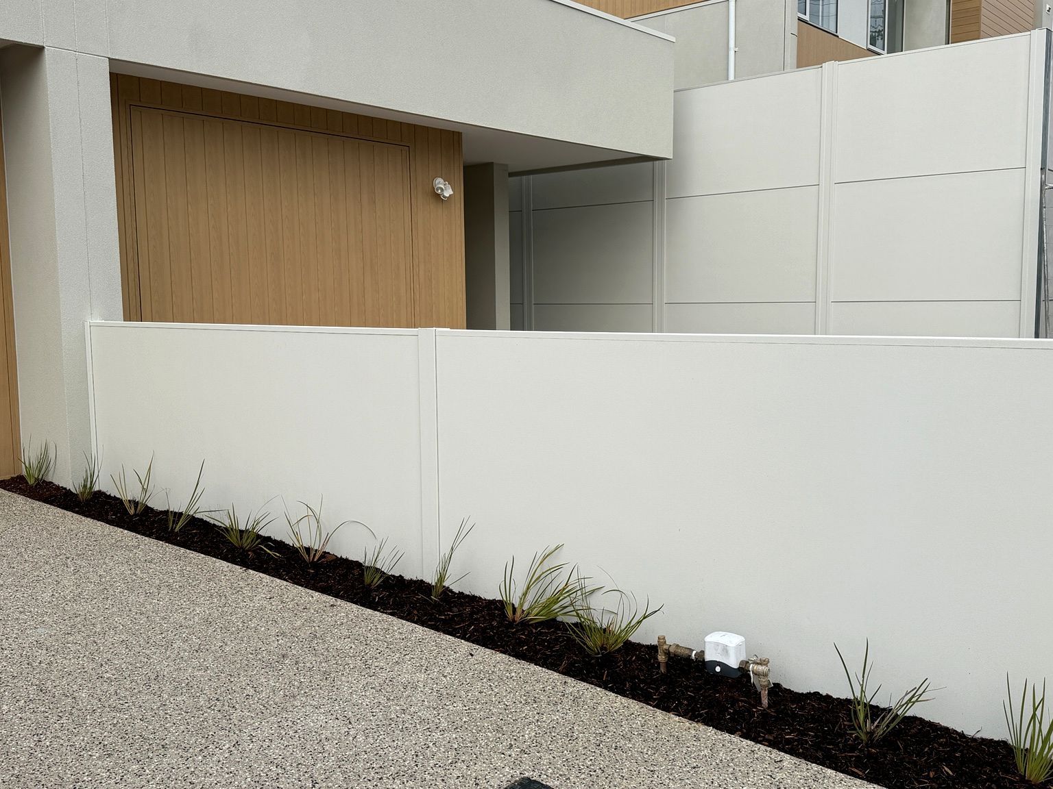 TrendWall boundary beside a timber-clad unit at Brighton.