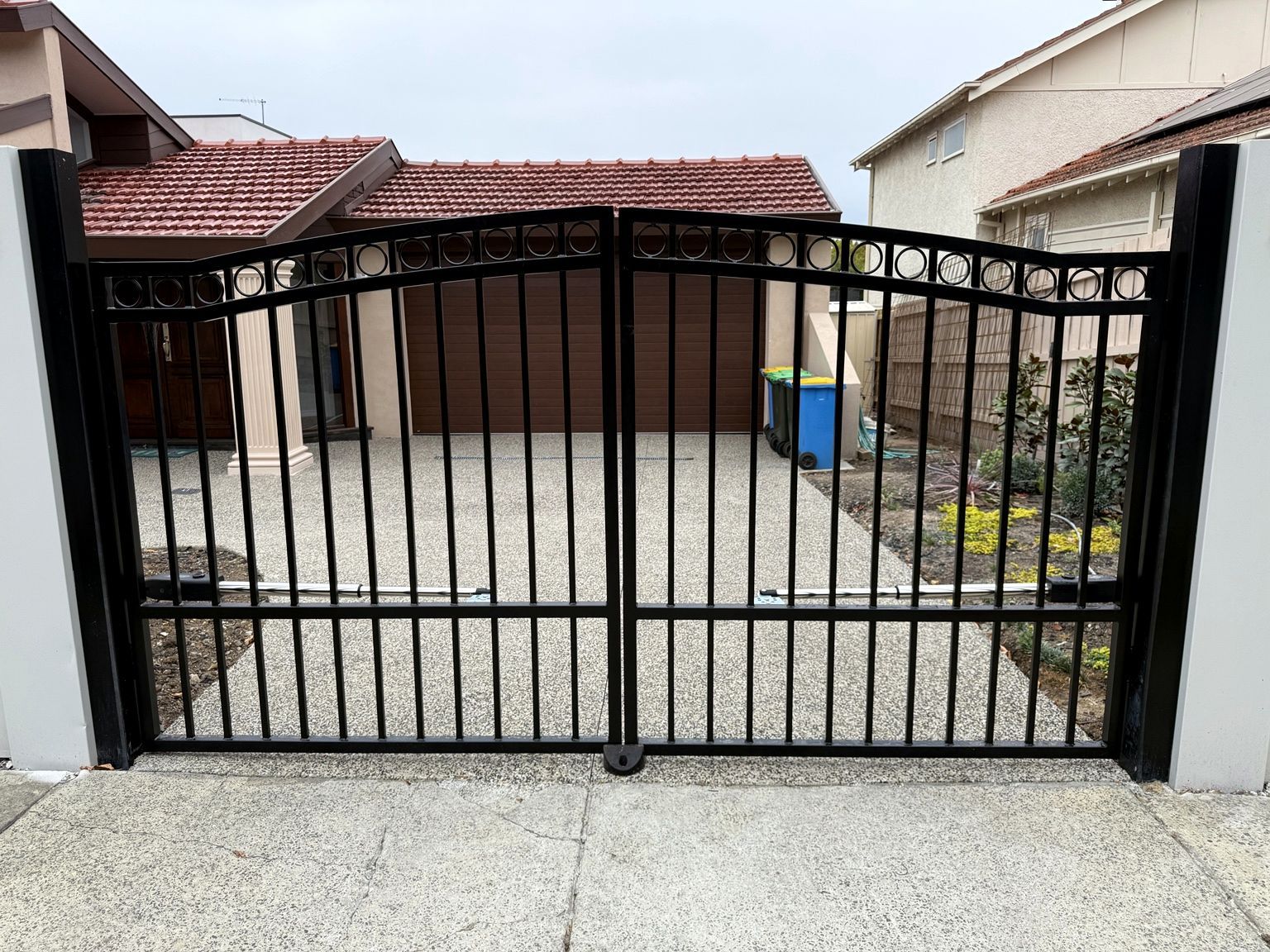 Black double swing gates set into a rendered EstateWall at Camberwell.