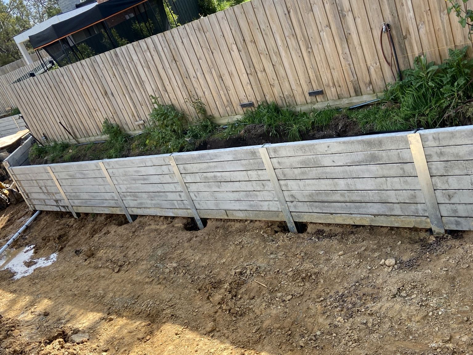 Mount Eliza project: Concrete sleeper retaining wall with heavy-duty concrete sleepers, uc125 steel posts, construction and progress photos. Photo 3 of 8.