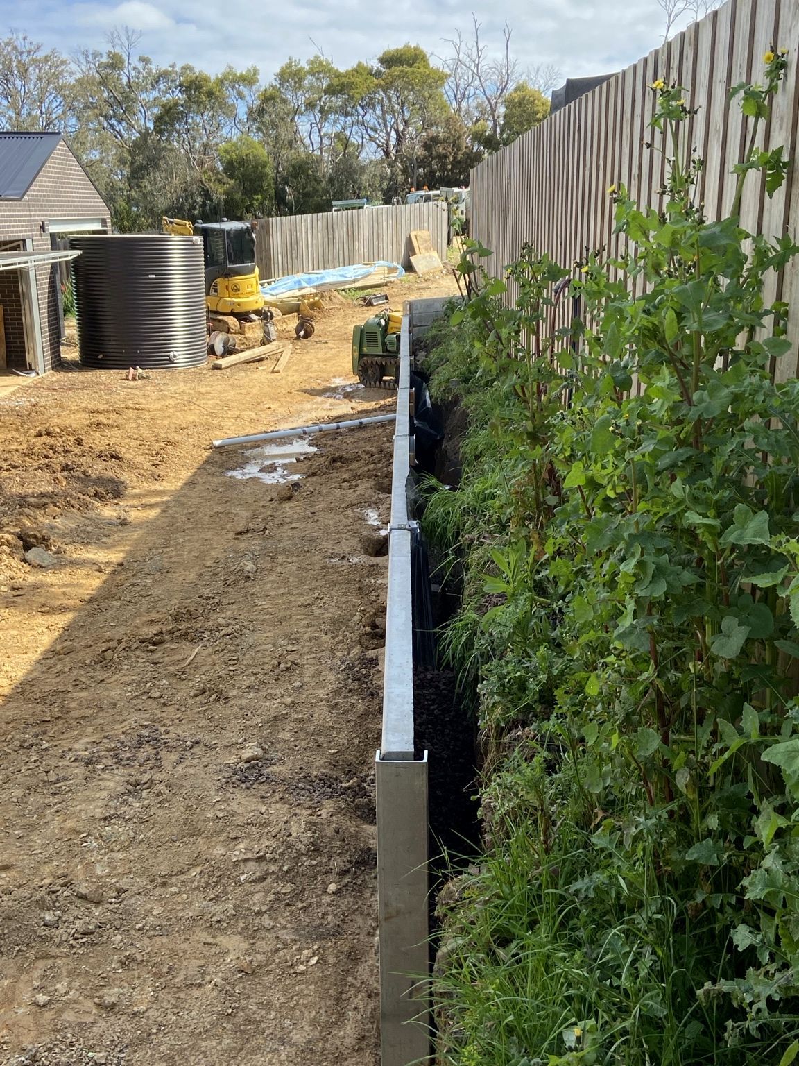 Mount Eliza project: Concrete sleeper retaining wall with heavy-duty concrete sleepers, uc125 steel posts, construction and progress photos. Photo 5 of 8.