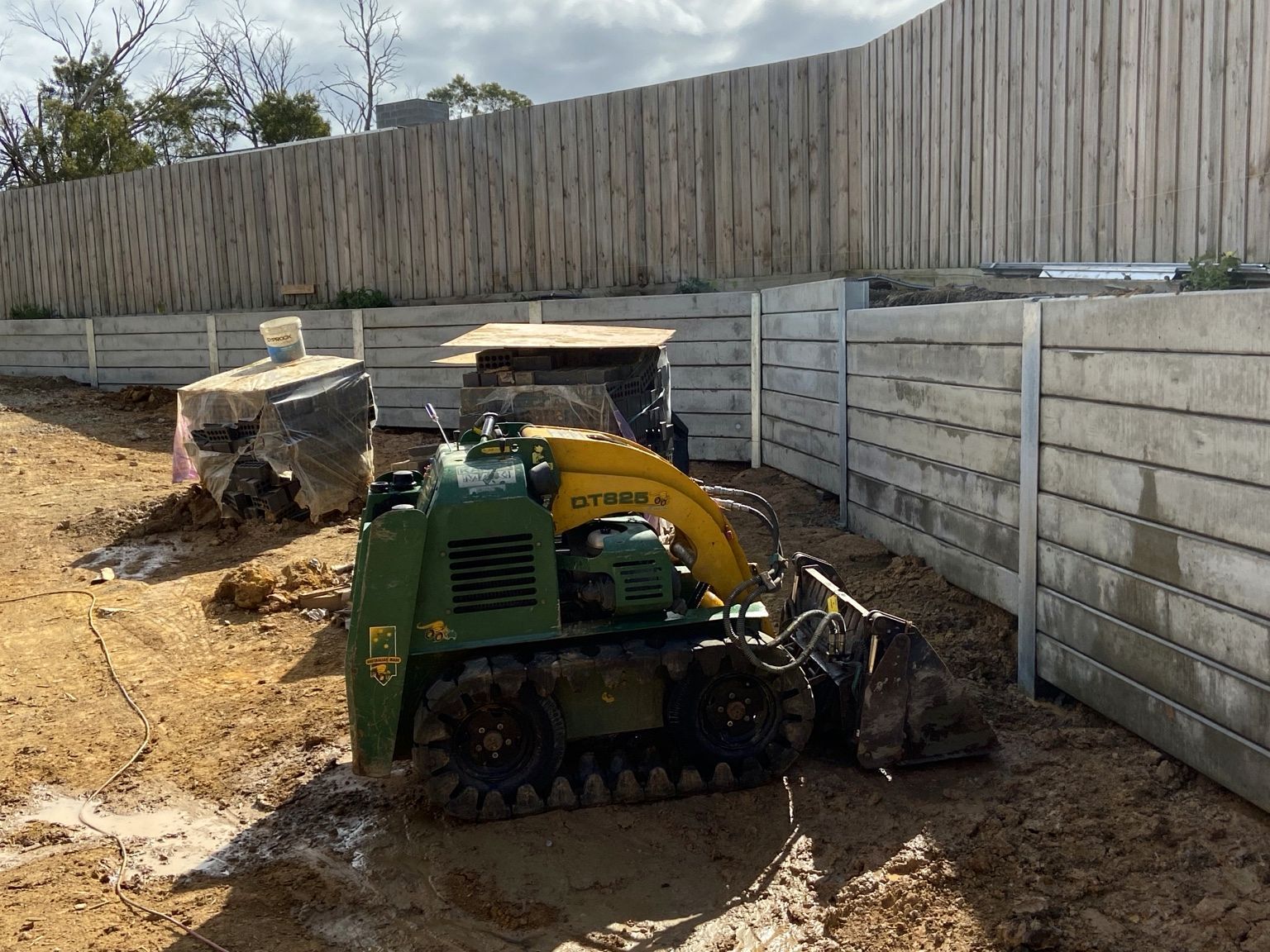 Mount Eliza project: Concrete sleeper retaining wall with heavy-duty concrete sleepers, uc125 steel posts, construction and progress photos. Photo 6 of 8.