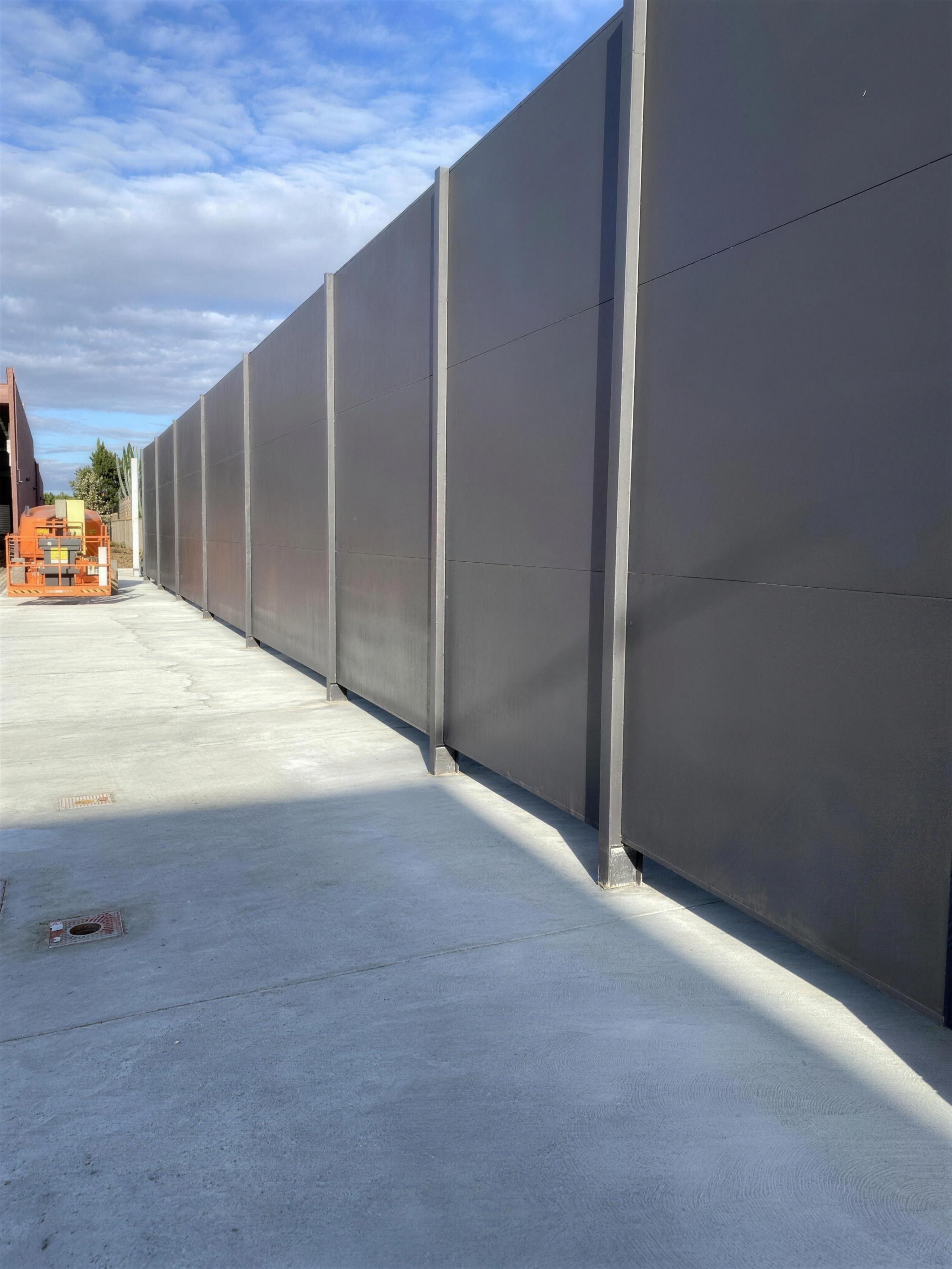 Tall grey acoustic wall panels on steel posts at the Point Cook loading dock.