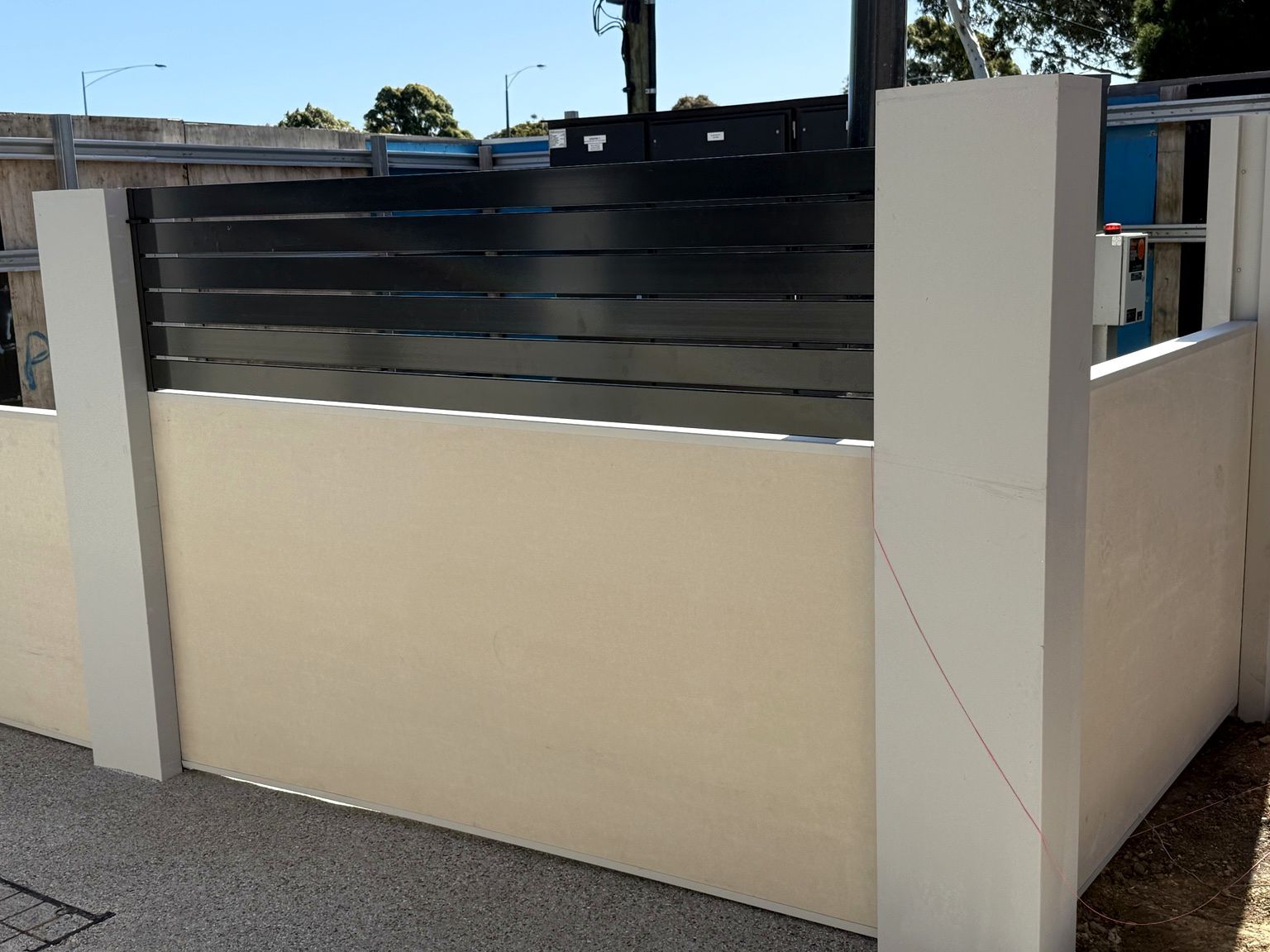 EstateWall with horizontal aluminium slat infills at The Glen development, Glen Waverley, apartments behind.