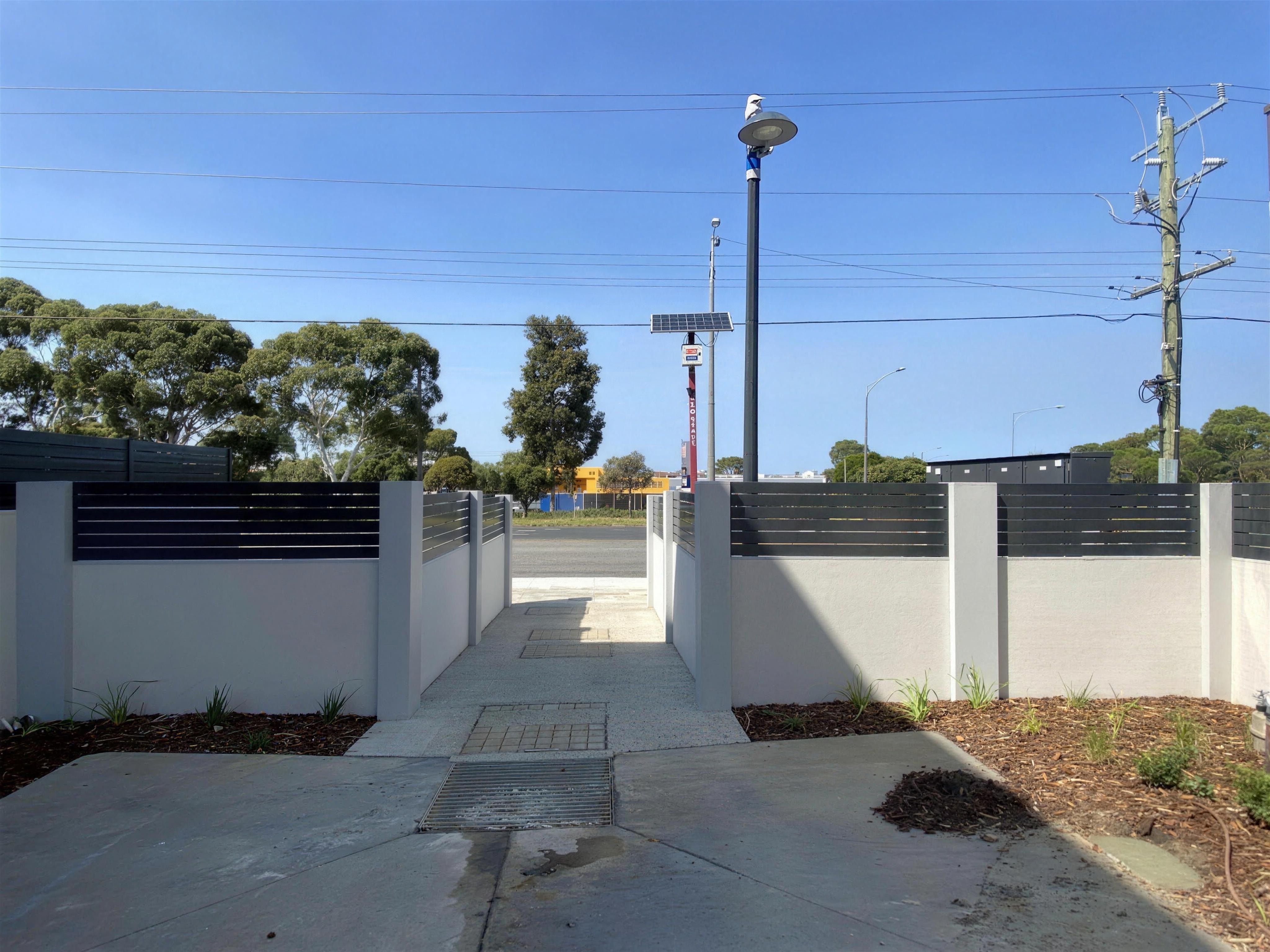 EstateWall with horizontal aluminium slat infills at The Glen development entrance, Glen Waverley.